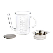 Roasting Glass Fat Separator with Gravy Strainer alongside a glass teapot and bowl, ideal for precise kitchen tasks and enhancing culinary experiences.