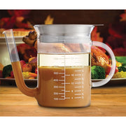 Roasting Glass Fat Separator with Gravy Strainer, featuring a measuring cup filled with brown liquid, ideal for precise cooking in the kitchen.