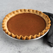 Nordic Ware | Naturals® High Dome Covered Pie Pan with a pie, showcasing its spacious dome cover, ideal for preserving pie freshness and accommodating toppings.