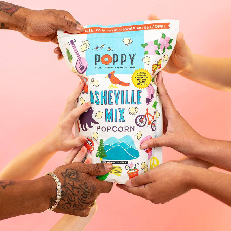 Poppy Hand-Crafted Popcorn - Asheville Mix Artist Bag Popcorn being shared, featuring playful Asheville icons, supporting Hurricane Helene relief with each purchase.