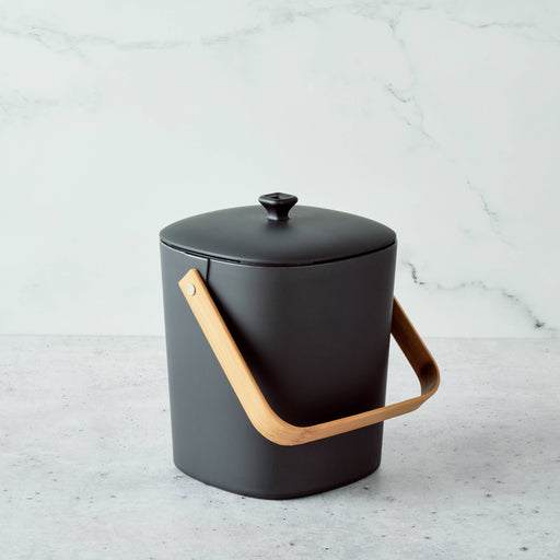 Bamboozle - Astrik Composter: Graphite, a matte-black, rounded compost bin with bamboo handle, designed for sustainable kitchen use and odor control.