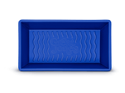 Great Jones | Breadwinner - Raspberry: A blue rectangular loaf pan with a wavy, corrugated nonstick bottom, perfect for effortless baking and easy release.