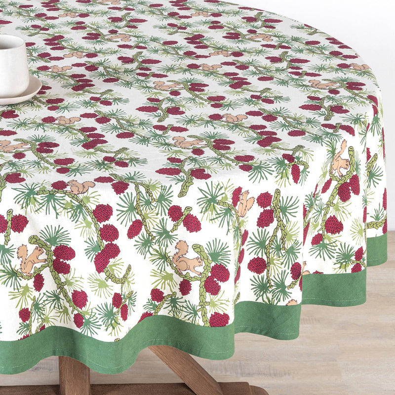 Couleur Nature - Squirrel and Pinecone Red & Brown Tablecloth: 71 x 71, featuring a woodland motif with squirrels and pinecones, topped with a white mug.