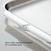 Close-up of Hestan | OvenBond Tri-Ply Bakeware Half Sheet Pan, showcasing extra-wide ergonomic handles for secure grip, ideal for even heat distribution in baking and roasting.