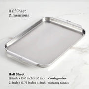 Hestan | OvenBond Tri-Ply Bakeware, Single Half Sheet Pan on marble countertop, showcasing its durable stainless steel build with wide handles for easy oven removal.