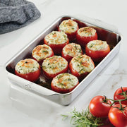 Hestan | Oven Bond Tri-Ply Bakeware, Rectangular Baker with stuffed tomatoes, showcasing its even heat distribution and ergonomic handles for easy oven handling.