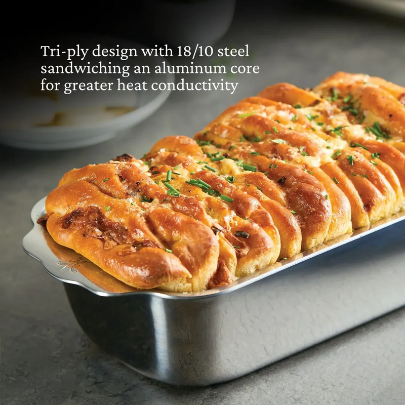 Hestan Provisions | OvenBond Tri-Ply Bakeware, 1-Pound Loaf Pan with cheese-and-herb bread, showcasing wide handles and tri-ply construction for even heat distribution.