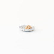 Sarah Kersten - Olive Dish: Basin Collection: Dove Grey, featuring a small, elegant dish holding a fortune cookie, ideal for versatile kitchen presentations.