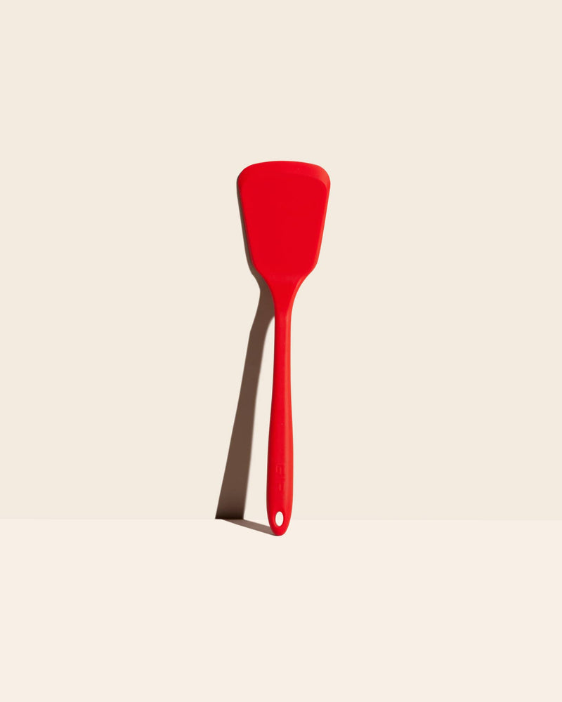 GIR Get It Right - GIR Ultimate Turner: Red, a durable spatula designed for lifting, flipping, and serving large meals, shown on a white surface. Dishwasher safe and heat resistant.