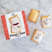 FarmSteady Pastry Tart Making Kit with tartlets featuring golden-brown crusts, white icing, and dried lavender, perfect for transforming nostalgic snacks into gourmet desserts.