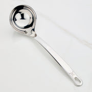 Hestan Provisions | Stainless Steel Ladle, 13 (5oz) on countertop, showcasing its deep bowl, ergonomic handle, and polished finish designed for effortless, drip-free pouring.