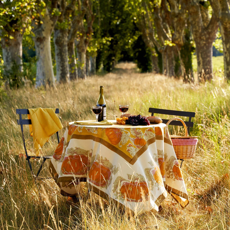 Caravan Home - Pumpkin Orange & Mustard Tablecloths: 71 x 71 decorates a picnic table with wine, grapes, and bread along a tree-lined path.
