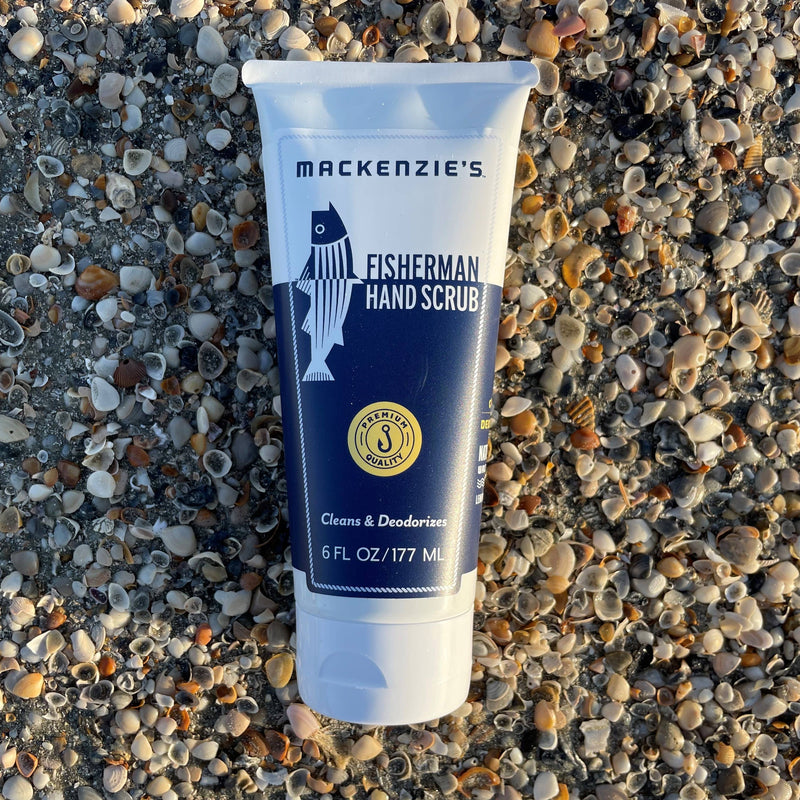 MacKenzie's Fisherman Hand Scrub 6 fl oz tube on seashells, perfect for cooks and gardeners, offering effective cleaning and deodorizing with walnut husks and lemon oil.
