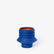 Areaware - Strata Plant Vessel: Blue ceramic planter with layered design inspired by Simone Brewster's jewelry, seamlessly concealing its saucer within the form.