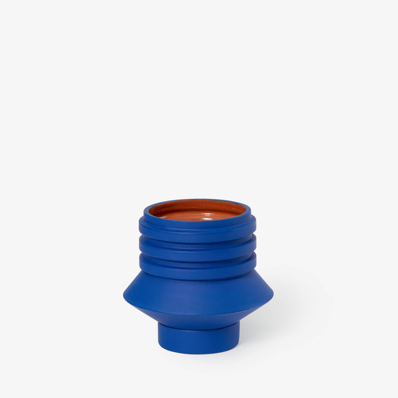 Areaware - Strata Plant Vessel: Blue ceramic planter with layered design inspired by Simone Brewster's jewelry, seamlessly concealing its saucer within the form.