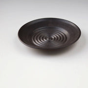 Gravesco Pottery - Garlic Grater Plate in Black, featuring concentric ridges for grating garlic, handcrafted stoneware with deep sides, ideal for creating oils and dips.