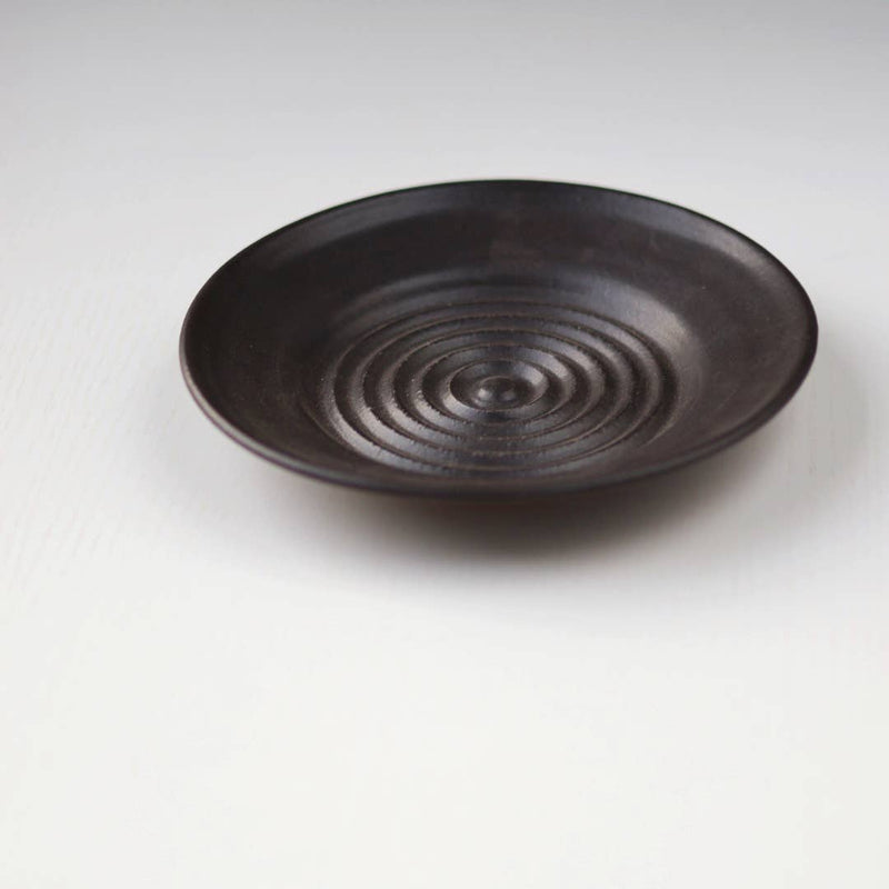 Gravesco Pottery - Garlic Grater Plate in Black, featuring concentric ridges for grating garlic, handcrafted stoneware with deep sides, ideal for creating oils and dips.