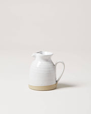 Farmhouse Pottery - Bell Pitcher: A handcrafted, off-white ceramic creamer with a spouted rim and curved handle, ideal for serving dressings or syrups.