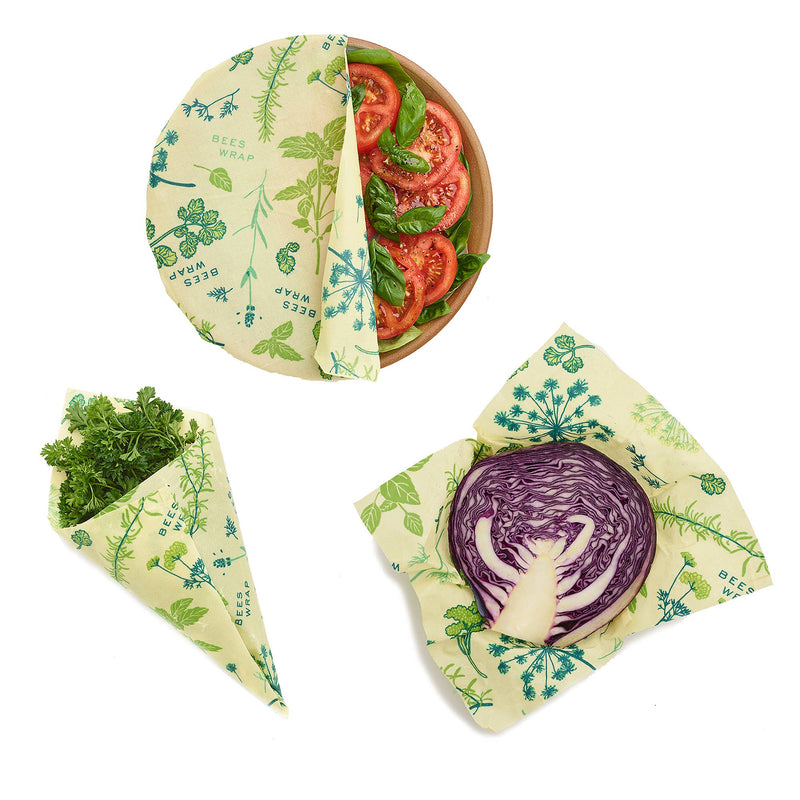 Bee's Wrap - Assorted 3 Pack - Herb Garden, featuring reusable wraps with plant-based wax for preserving vegetables, shown alongside wrapped produce and fresh ingredients.