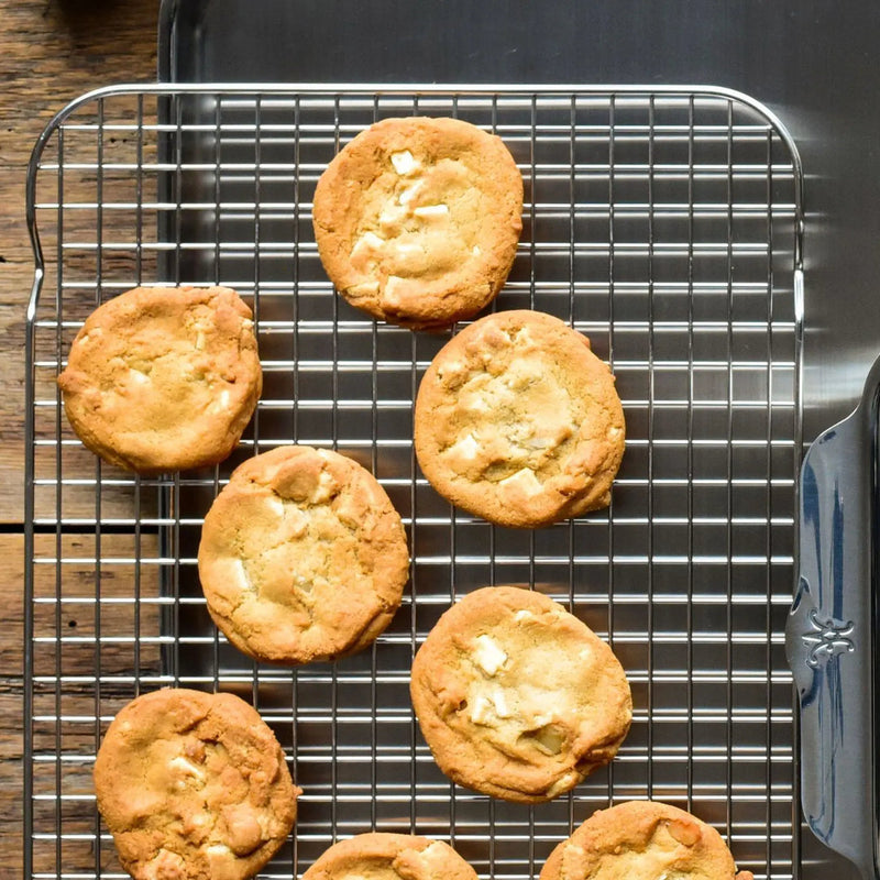 Hestan | OvenBond Tri-Ply Medium Rack holding freshly baked cookies with white-chocolate chunks, showcasing its versatility and premium stainless steel design.