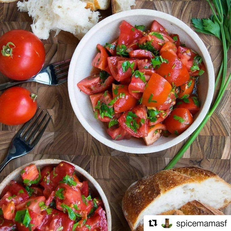 Rustic tomato salad with fresh herbs and crusty bread, ideal for enhancing with Burlap & Barrel - Cured Sumac for added brightness and flavor.