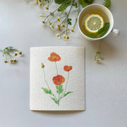Ink and Fiber Designs - California Orange Poppy Swedish Dishcloth with lemon and floral design, eco-friendly, ideal for kitchen use, absorbing spills efficiently.
