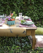 Hester & Cook | Farmer's Market Runner displayed on an outdoor table set with vegetables and tableware, capturing a rustic dining ambiance.
