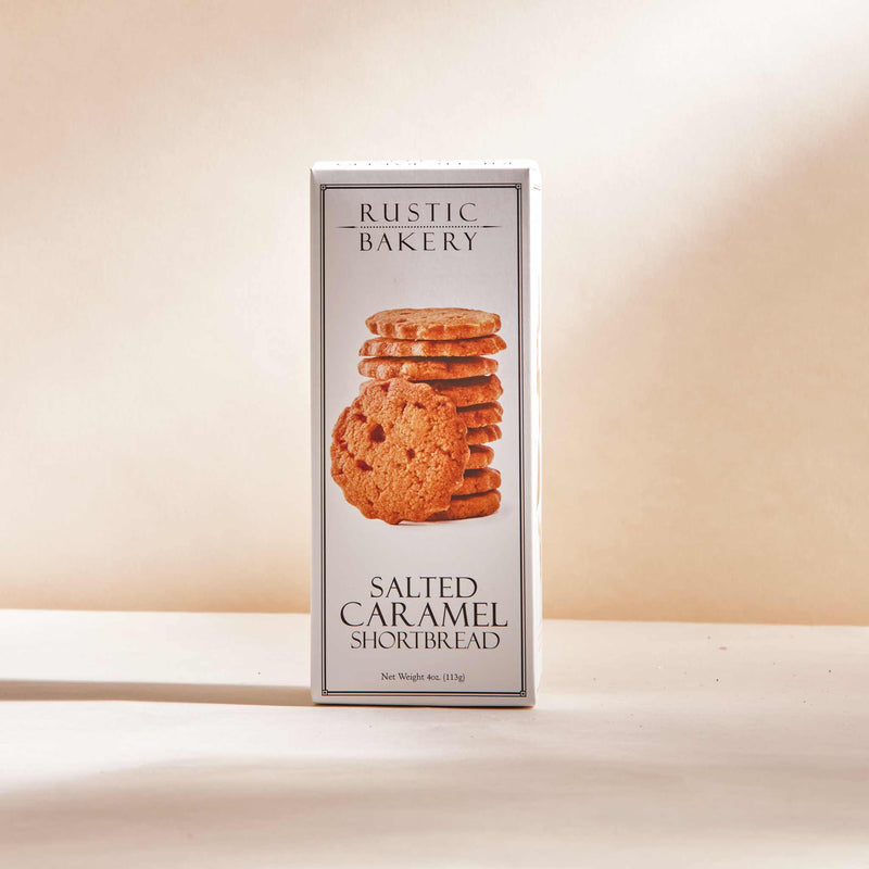 Rustic Bakery - Salted Caramel Shortbread (12 Boxes) featuring buttery shortbread with salted caramel, displayed in a rectangular package with stacked cookies. Net weight: 4 oz (113 g).