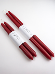 Mo&Co Home - Berry Red Dipped Beeswax Taper Candles: Two bundles of four handcrafted, 14-inch candles with cotton wicks, elegantly packaged on a white surface.