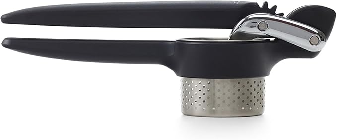 Chef'n Potato Ricer close-up, showcasing a black and silver press with a metal surface and gear details, ideal for easy mashing tasks.