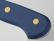 Wüsthof Classic 5 Serrated Utility Knife, close-up. Ideal for slicing through tough surfaces, showcasing precision craftsmanship available at Athens Cooks.