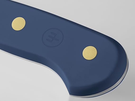 Wüsthof Classic 5 Serrated Utility Knife, close-up. Ideal for slicing through tough surfaces, showcasing precision craftsmanship available at Athens Cooks.