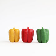 Bell Pepper Beeswax Candle: Red - A uniquely crafted candle in the shape of a red bell pepper, symbolizing a collaboration of farm-fresh aesthetics and natural beeswax.