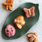 Nordic Ware | Backyard Bugs Pan: Detailed insect-shaped cake pan featuring butterflies, dragonflies, ladybugs, and bees for creative summer baking. Made of heavy cast aluminum.