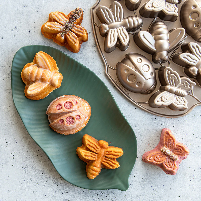 Nordic Ware | Backyard Bugs Pan: Heavy cast aluminum pan featuring detailed insect shapes for baking, including butterflies, dragonflies, ladybugs, and bees. Ideal for summer-themed desserts.
