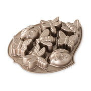 Nordic Ware | Backyard Bugs Pan, a heavy cast aluminum baking mold featuring crisp detailing of 8 bug shapes: butterflies, dragonflies, ladybugs, and bees, ideal for summer cakes.