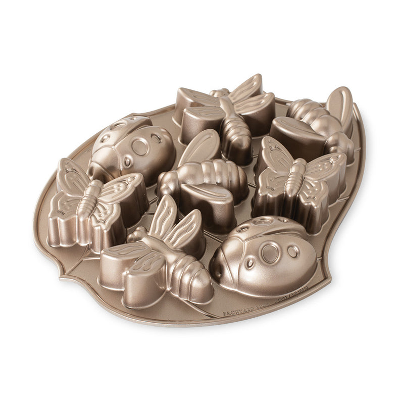 Nordic Ware | Backyard Bugs Pan, a heavy cast aluminum baking mold featuring crisp detailing of 8 bug shapes: butterflies, dragonflies, ladybugs, and bees, ideal for summer cakes.
