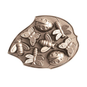 Nordic Ware | Backyard Bugs Pan featuring insect-shaped molds, including butterflies, dragonflies, ladybugs, and bees, crafted from heavy cast aluminum for detailed cake baking.