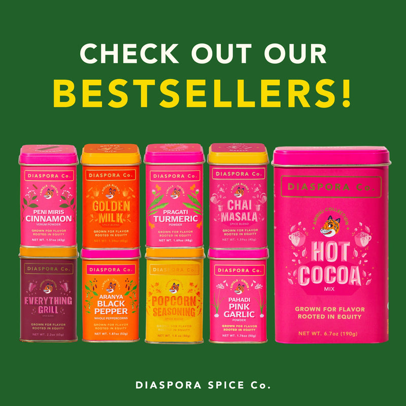 Diaspora Spice Co. Hot Cocoa Mix tin, promoting naturally-sweetened hot chocolate, made with Anamalai Cacao and Madhur Jaggery, surrounded by other spice tins.