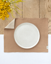 Double layer linen placemat set of 2: Grey blue, on a table with a white plate and fork, showcasing its soft, natural texture.