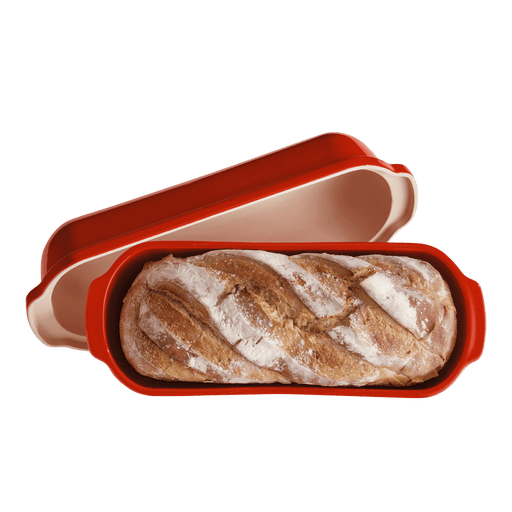 Emile Henry Loaf Bread Bakers: Red ceramic bread cloche with lid removed, showcasing a freshly baked artisan loaf inside, ideal for crusty, golden loaves.
