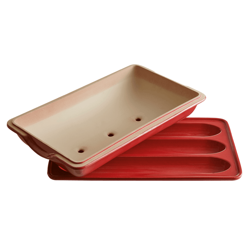 Emile Henry | Baguette Baker, Burgundy: Two-piece set with grooved tray and vented lid for baking three mini-baguettes, ensuring a crispy crust and easy dough release.