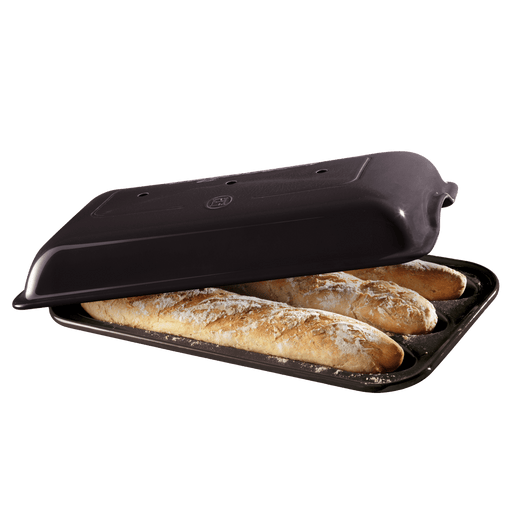 Emile Henry Baguette Baker in charcoal — open baker with three freshly baked baguettes