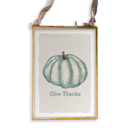 Framed art print with teal pumpkin illustration and Give Thanks text, hung by velvet ribbon. Part of French Graffiti - Blue Pumpkin collection at Athens Cooks.