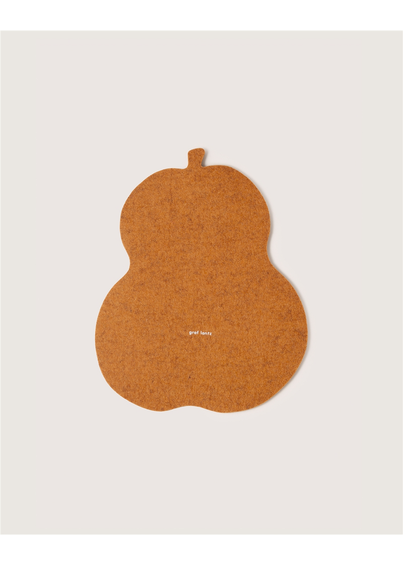 Graf Lantz - Merino Wool Squash Trivet - Miso, featuring a pumpkin-shaped design with a white logo, ideal for adding style to kitchen settings.