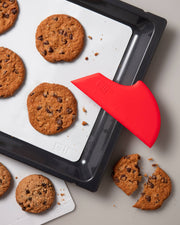 GIR Get It Right - GIR Scraper: Slate next to a tray of cookies, showcasing its versatility for baking and kitchen tasks.