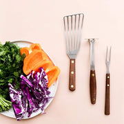 Lamson | Vintage Mini Avocado + Spud Masher showcased with vegetables and utensils, highlighting its compact design for efficient mashing in small bowls.