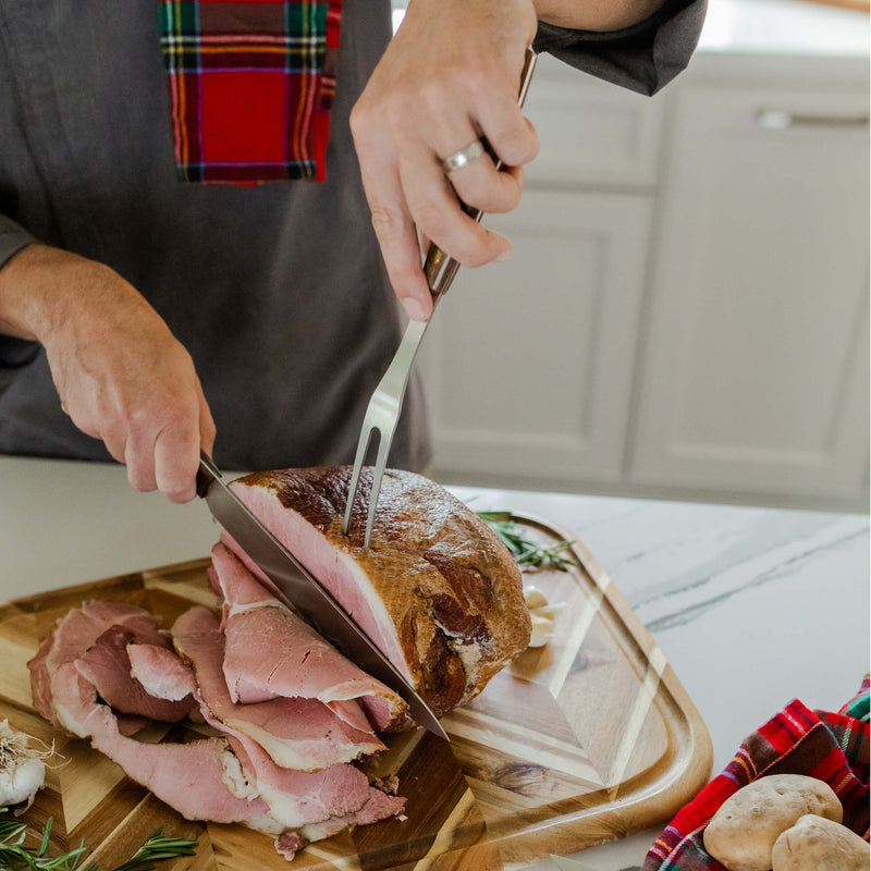 Lamson | Vintage 2pc Walnut Carving Set in use, showcasing precision cutting of ham on a board, highlighting high-quality craftsmanship and ergonomic design.