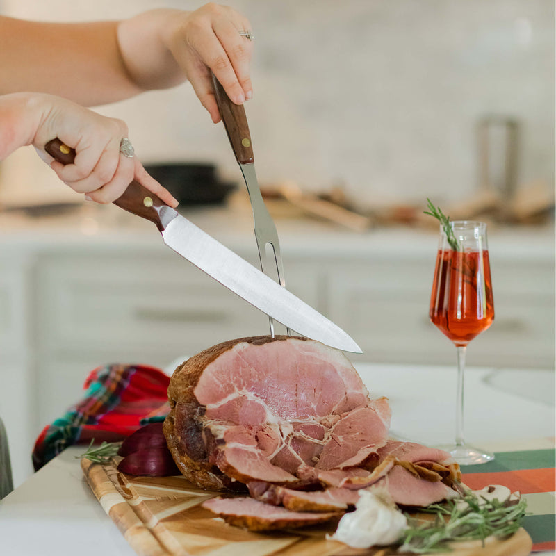 Lamson | Vintage 2pc Walnut Carving Set, featuring a sliced piece of meat with knife and fork, highlighting precision cutting in a culinary setting.