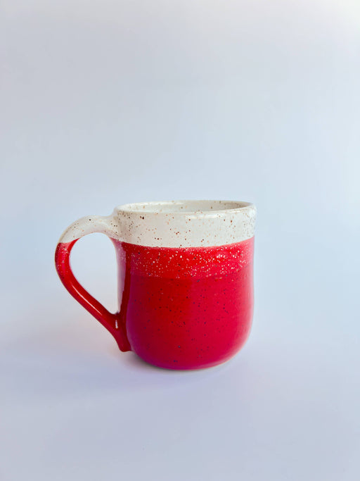 RachaelPots - 18 Oz Jumbo Mug: Red, a hand-thrown ceramic mug with a glossy red exterior and speckled off-white rim, ideal for coffee or soup.